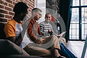 young multicutural businessmen sitting on sofa and discussing business ideas,stock image