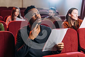 Young multiethnic actors reading scripts in photo