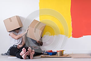 Young multiethnic couple playing with cardboard boxes