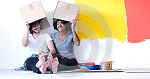 Young multiethnic couple playing with cardboard boxes