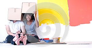 Young multiethnic couple playing with cardboard boxes