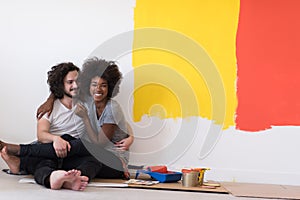 Young multiethnic couple relaxing after painting