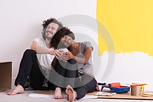 Young multiethnic couple relaxing after painting