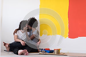 Young multiethnic couple relaxing after painting