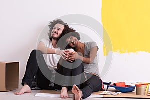 Young multiethnic couple relaxing after painting
