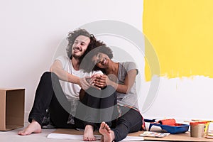 Young multiethnic couple relaxing after painting