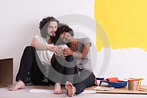 Young multiethnic couple relaxing after painting