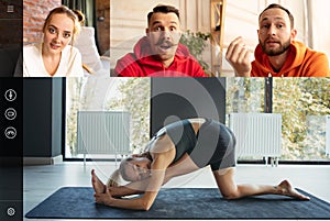 Young multiethnic people, men and women watching yoga trainings, sport tv programme using video app. PC, laptop screen