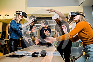 Young multiracial business People wearing virtual reality goggles with touching air during VR Meeting Conference at the