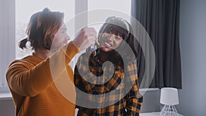 Young multiracial couple getting keys of their new property. Buyers of the first house