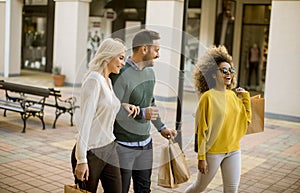 young multiracial friends shopping in mall together