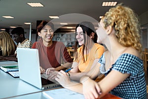 Young multiracial people studying together inside university library