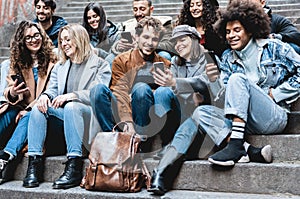 Young multiracial people using mobile phones outdoor - Main focus on girl face with grey hat