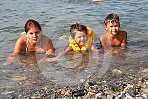 Young mum and children in water