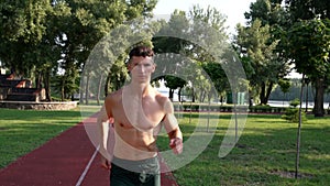young muscular athletic man runs in the park, energizer