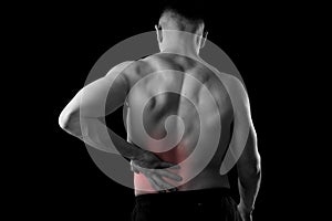 Young muscular body sport man holding sore low back waist are suffering pain in athlete stress