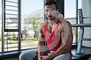 Young Muscular Caucasian Man Resting At The Bench