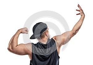 Young muscular guy shows arm muscles - biceps.