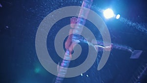 Young muscular man acrobat jumping on the trampoline - slow-motion, bottom view