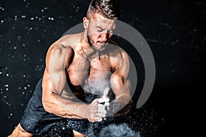 Young muscular man with big sweaty muscles doing push ups workout training with clap his hand above the barbell weight plate on th