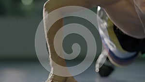 Young muscular man doing core exercise on fitness mat in the gym. Fit female doing press-ups during the training in the