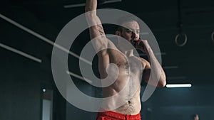 Young muscular man doing exercises with kettlebell in gym. Weightlifting workout. Sports, fitness concept. 4K slow