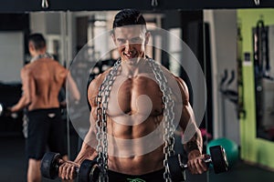 Young muscular man in the gym doing exercise