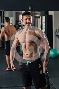 Young muscular man in the gym doing exercise