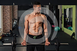 Young muscular man in the gym doing exercise