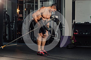 Young muscular man in the gym doing exercise