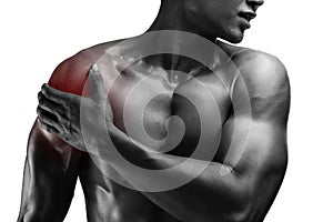 young muscular man with shoulder pain , isolated on white background, monochrome photo