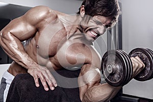 Young muscular man workout in gym