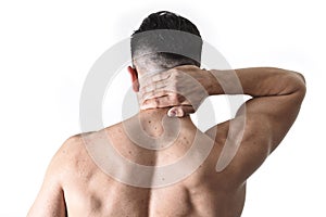 Young muscular sport man holding sore neck massaging cervical area suffering body pain