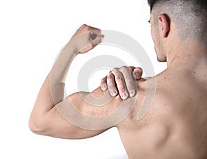 Young muscular sport man holding sore shoulder in pain touching massaging in workout stress