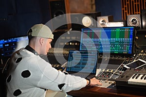 Young music producer working in sound recording studio