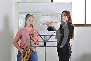 Young music students study sheet music lesson in the classroom.