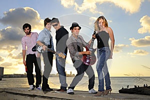 Young musical band posing with instruments