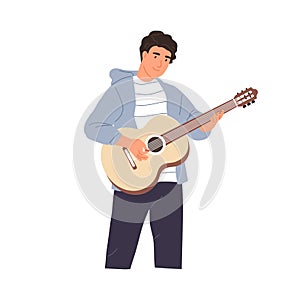 Young musician performing music on acoustic guitar. Happy guitarist standing and playing romantic melody. String