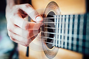 Young musician playing acoustic guitar