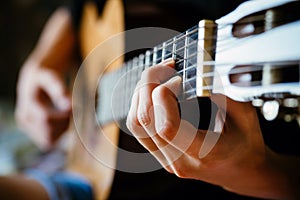 Young musician playing acoustic guitar