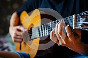 Young musician playing acoustic guitar