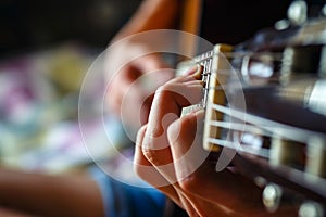 Young musician playing acoustic guitar