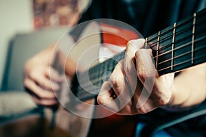 Young musician playing acoustic guitar