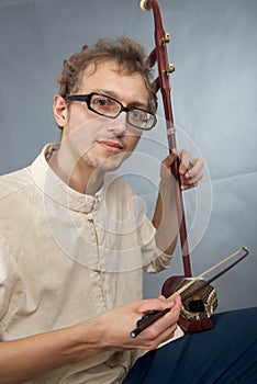 Young musician playing in erhu.