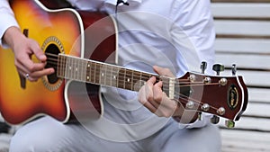 Young Musician Playing Solo On Classic Guitar, Finger style Close Up. An acoustic guitar uses only acoustic means to