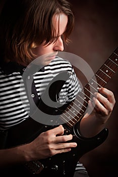 Young Musician Plays His Electric Guitar