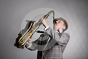 Young musician plays the saxophone.