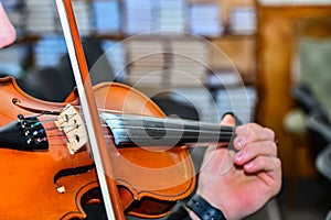 A young musician plays the violin in a symphony orchestra