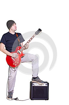 Young musician with red guitar isolated on white. Rockstar man playing electric guitar. Guy with a guitar combo