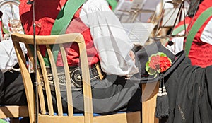 Young musician in typical costume during an autumn local celebration in Val di Funes South Tyrol